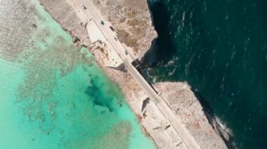 The drone footage of the Glass Window Bridge in the Bahamas. Turquoise water of Eleuthera and Atlantic.