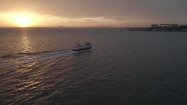A high angle view of a white boat sailing on Madeira Island, Portugal
