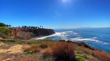 A beautiful aerial drone view of a shiny coastline on a sunny day in Rancho Palos Verdes, California