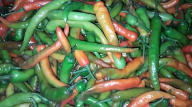 A lot of Red and Green Chili Peppers on the Shop Shelf in the Supermarket. Huo Chili peppers. Red-green spicy seasoning natural food
