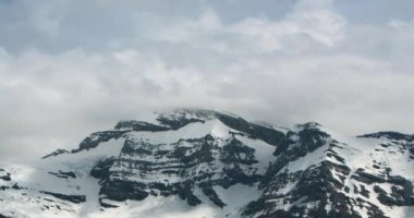 A timelapse of a mountain with clouds in the background in Champery, Switzerland