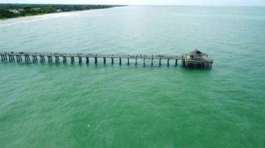 A beautiful high angle HD footage of a long bridge in the sea at Naples Beach Fiori