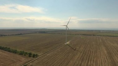 A bird's eye view of windmills in agricultural fields in Zatoka, Ukraine on a sunny day