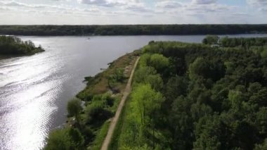 An aerial view of the Lake of Zegrze near the forest on a sunny morning