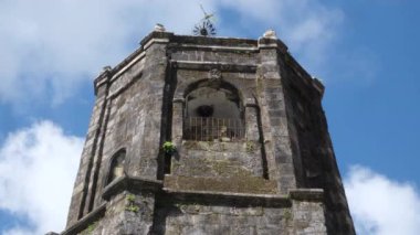 A beautiful view of the ancient church bell toof under the blue cloudy sky