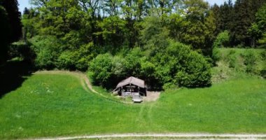 An aerial footage of a cabin with fields and trees in Bavaria, Germany