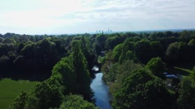 An Aerial shot of a bridge on the Bridgewater Canal between lush green trees in Cheshire, UK