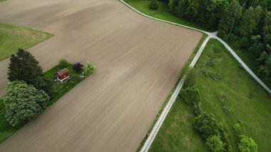 a camera move over empty brown and green fields in the country side of Switzerland