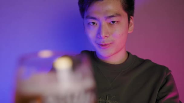 Slow Motion Asian Male Drinking Glass Beer Wall Pink Blue — Stockvideo