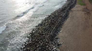 An aerial view of soft ocean waves with foam