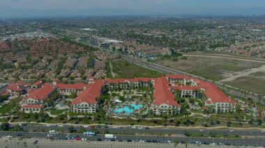 An aerial view of hihgways, houses and resort buildings in Huntington Beach, California
