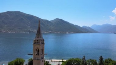 A drone footage of a catholic church by the sea in Dobrota, Montenegro