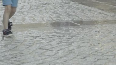 Lady running and jumping over puddle