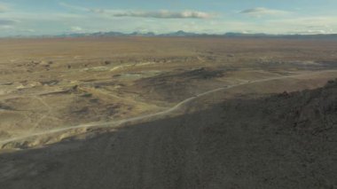 An aerial view of the road in the middle of desert in Trona, CA