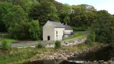 An old mill building surrounded by greenery in Dunbeath Strath, Scottish Highlands