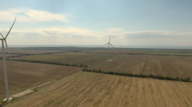 A bird's eye view of windmills in agricultural fields in Zatoka, Ukraine on a sunny day