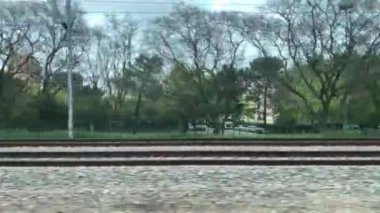 A beautiful view of a city from a train window on a cloudy day