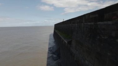 An aerial view of the Watchet Harbor Lighthouse and dock in Somerset, England