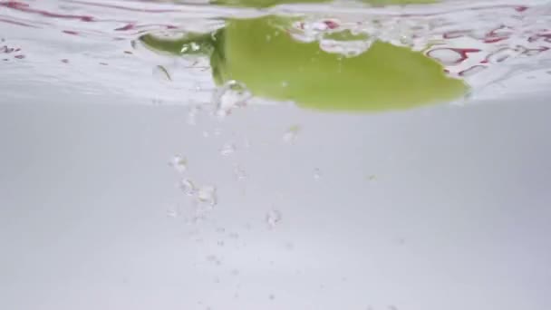 Green Peppers Dropping Water White Background — Video
