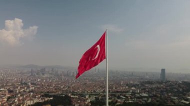 The aerial drone footage of the flag of Turkey on Camlica Hill against the Istanbul cityscape.
