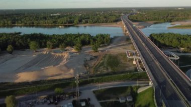A drone footage of a bridge over the river on a cool spring daytime