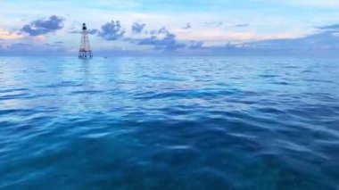 A calm blue sea at sunset