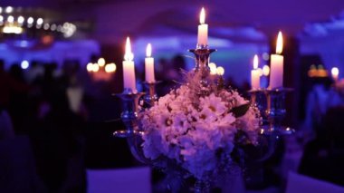 The beautiful interior with candles on the tables at the wedding venue