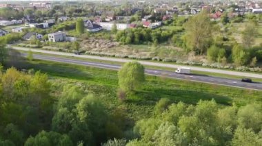 An aerial shot of the traffic on an asphalt highway in the suburbs of Radom, Poland