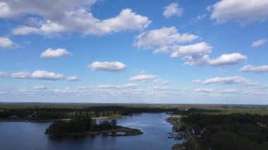 An aerial view of a bright blue sky with clouds over Lake of Zegrze in Poland