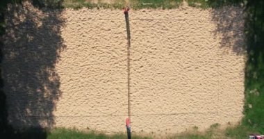 A drone shot zooming out of trees in a park in the small Gstadt am Chiemsee town in Bavaria