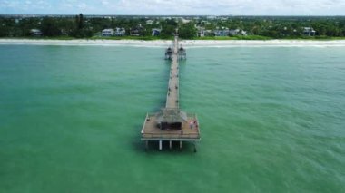 A beautiful high angle HD footage of a long bridge in the sea at Naples beach