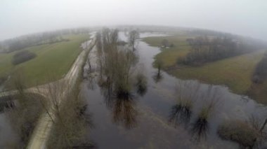 A beautiful top view of flooded land in a park with trees