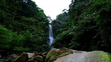 A low-angle view of a beautiful waterfall in Cigentis, Indonesia