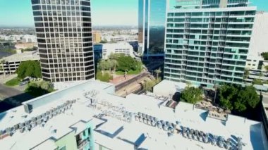 An aerial slow movement around downtown Phoenix Arizona surrounded by buildings
