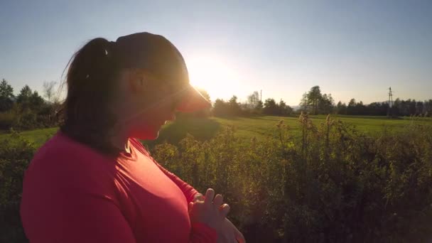 Caucasian Young Female Cap Setting Smartwatch Running Sunset — Vídeos de Stock