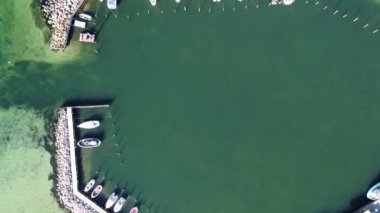The 4K aerial drone top footage of the semi-natural sea harbor with boats and yachts view