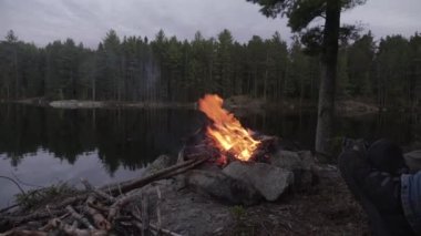 An HD of the Feet by the fire in the wilderness Canadian Backcountry
