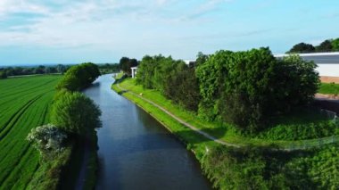 An Aerial shot of the Bridgewater canal with farmland to the left and Daresbury Tech Park to right