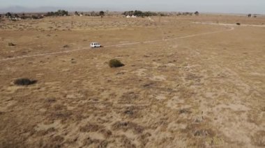 A beautiful view of a car in a desert in a daylight