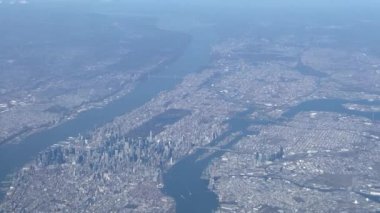 An aerial view of a city divided by rivers