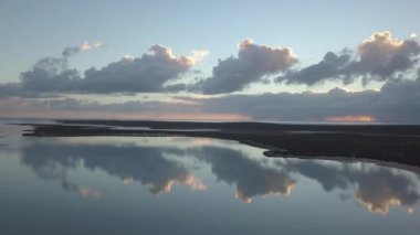 A beautiful shot of sunset clouds reflected on the sea