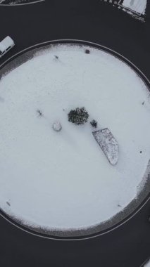 A vertical aerial view of a round point with snow in Chamonix, Le