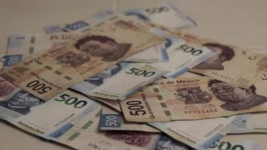 A closeup footage of a stack of Mexican banknotes of five hundred Pesos