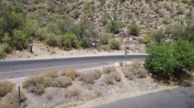 A drone lifting off the ground overseen mountains and hovering over Lake Saguaro, Arizona