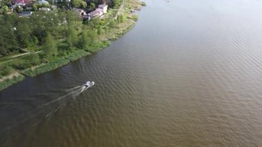 An aerial view of a boat sailing in the Lake of Zegrze in Poland