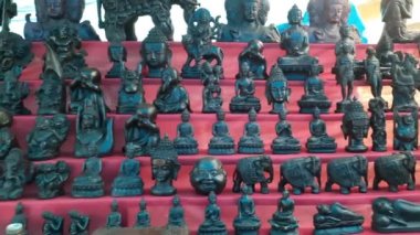 Indian gods statues stall in a market in Mumbai, India The market street on Elephanta island in India.