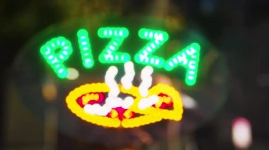 PIZZA SIGN  4K HD NEON SIGN IN WINDOW OF A PIZZA SHOP SHOWING PIZZA STEAMING HOT OPEN FOR BUSINESS