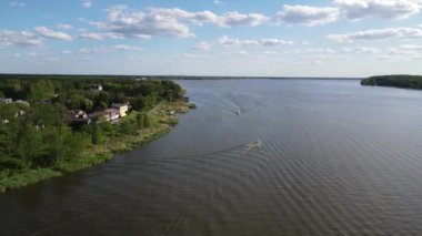 An aerial view of the Zegrzynskie lake and buildings on a green shore