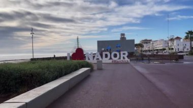 Man uses his smartphone in a cafeteria