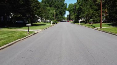 A drone footage of a street decorated with US flags on a Memorial Day